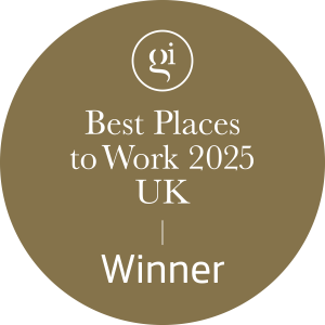 award badge, gold circular badge with text "Best Places to Work 2025 UK Winner" for industry recognition