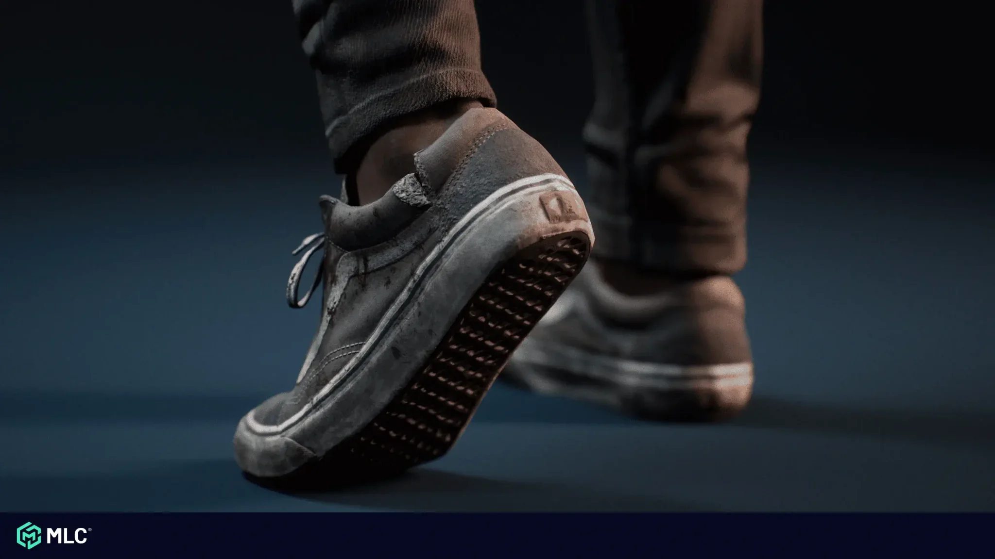Athletic worn-out sneaker with scuffed sole and creased fabric on a dark background.