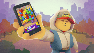 Victory game character holding smartphone with match-three puzzle display in a colourful outdoor park scene.