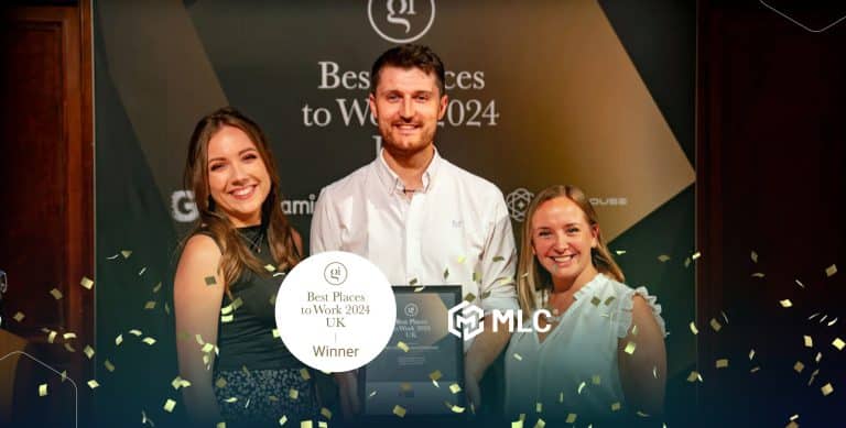 Winner team celebrating at an award ceremony holding a framed certificate, with a backdrop displaying "Best Places to Work 2024 UK" and "MLC" logo, surrounded by gold confetti.