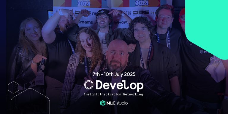 People at a gaming industry event posing for a group photo with a backdrop showing logos and event dates.